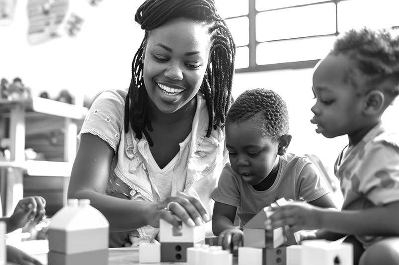 teacher with two children playing with blocks